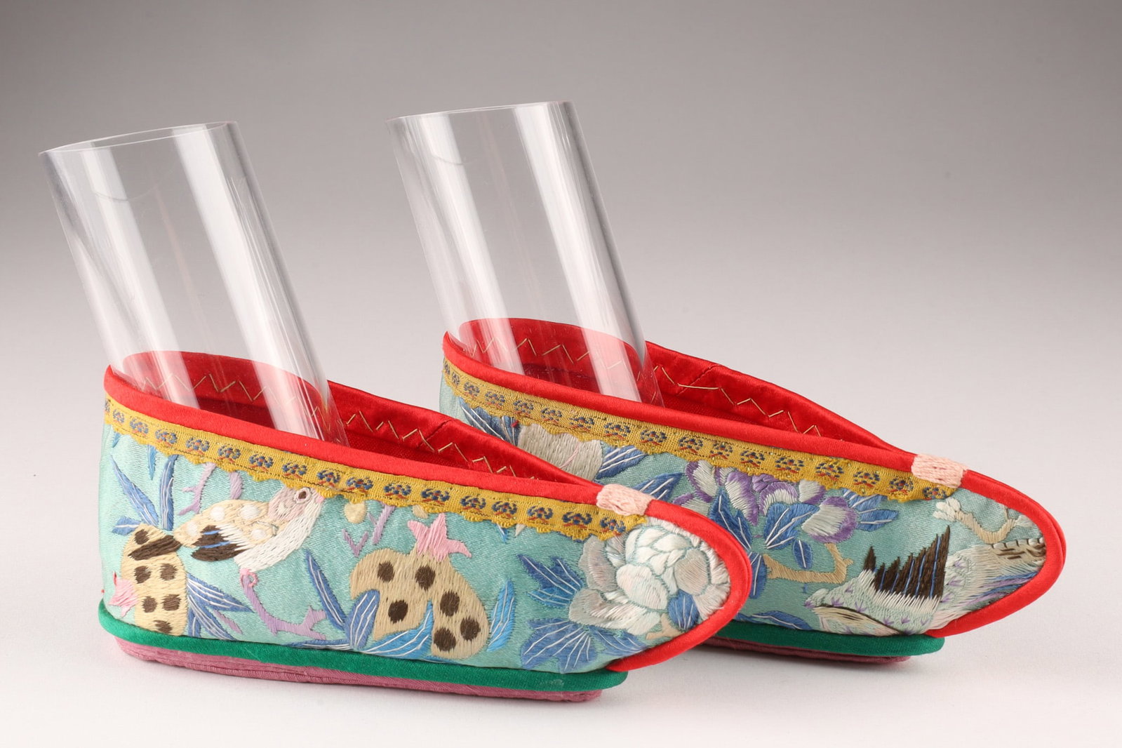 Pair of Chinese Qing Satin Embroidered Lotus Shoes Bound Feet: THE SIMON CHANG COLLECTION - Chinese pair of childs small satin lotus shoes for bound feet, the outside of a pale blue satin hand embroidered in silk with images of birds and stylized floral design, r