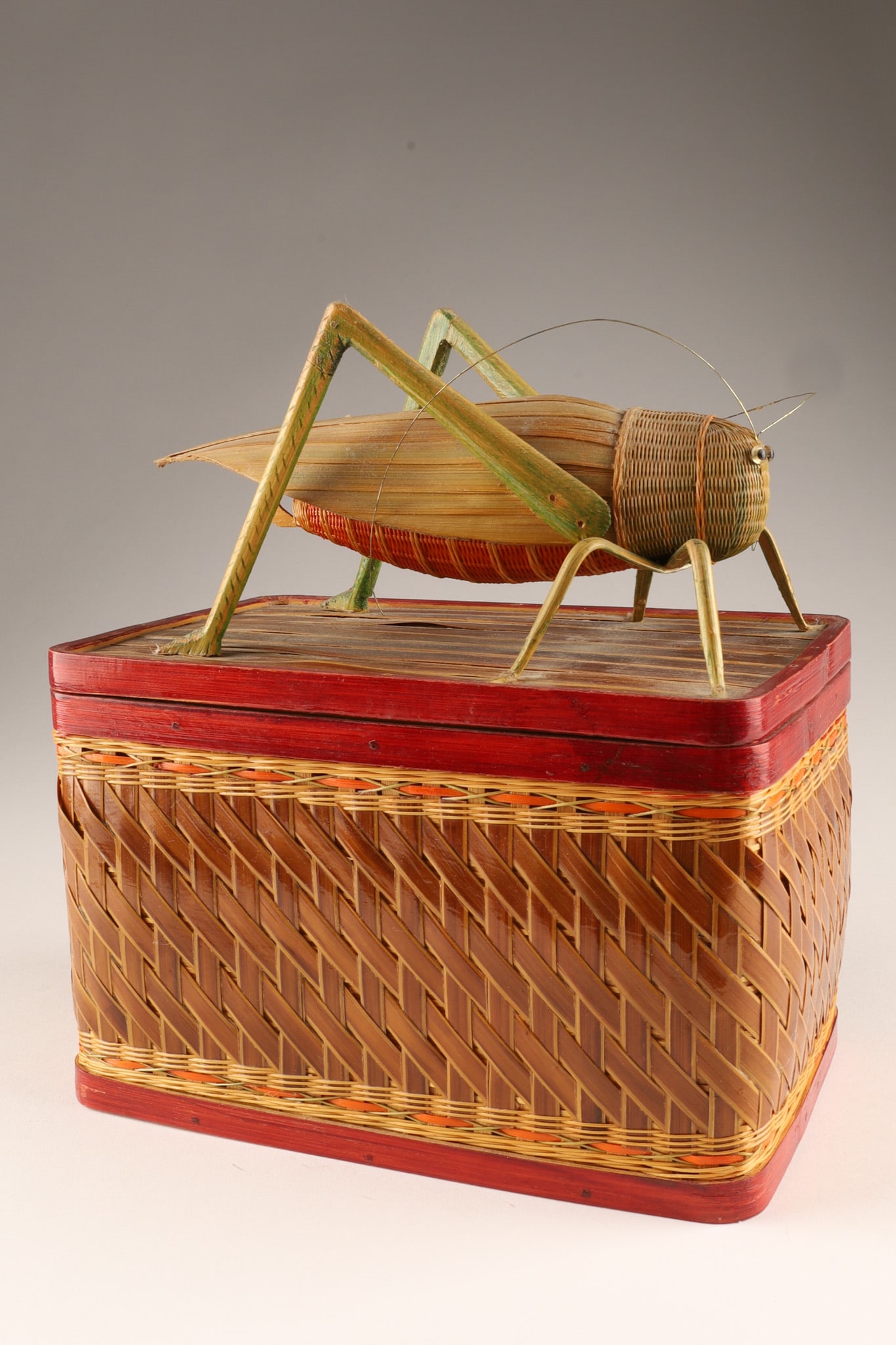Shanghai Weave Bamboo Rattan Box Green Grasshopper Lid: THE SIMON CHANG COLLECTION - A rectangular shaped vintage Chinese handmade woven Shanghai weave rattan and bamboo box with red painted wood rims, the top with an intricately woven green grasshopper in