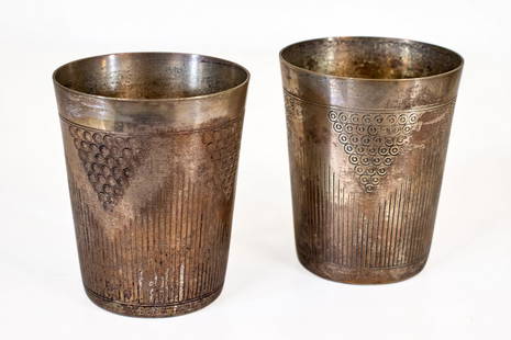 French Beakers (French, 19th Century): Two (2) beakers. Modernist paired etched grape motif beakers. Circa 1890s. Stamped: Metal Blanc. Hallmark: unknown. 3 1/4 x 2 1/8 inches.