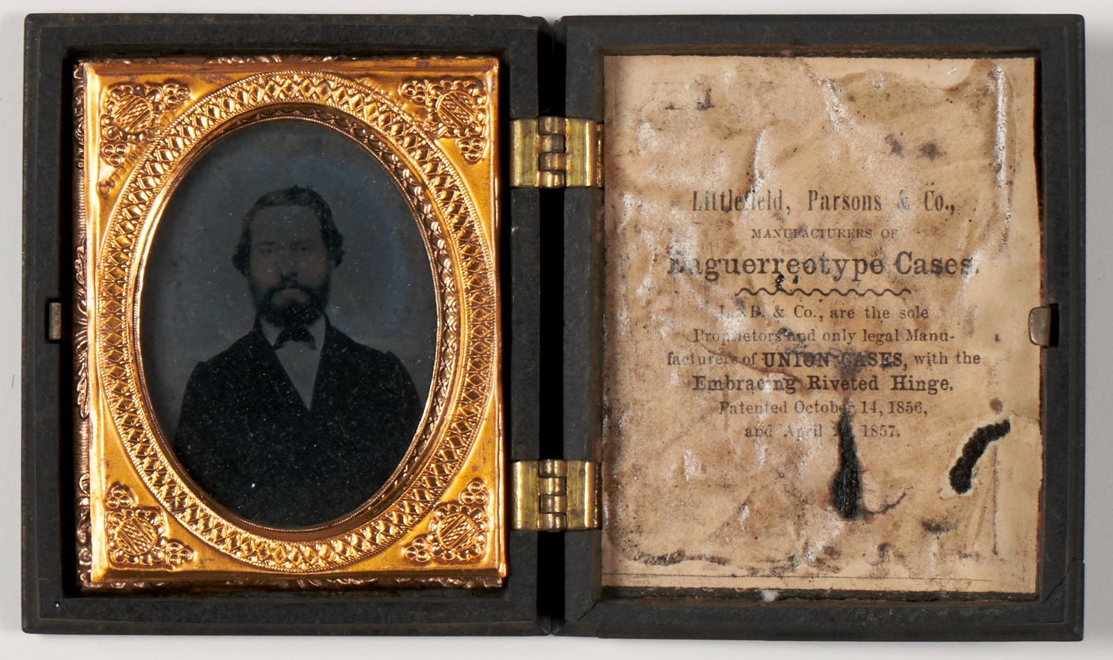 Period Daguerreotype Cases: Smaller with ambrotype portrait of a gentlemen on glass. Larger appears unused. 3 3/4 x 3 1/4" (Largest frame).