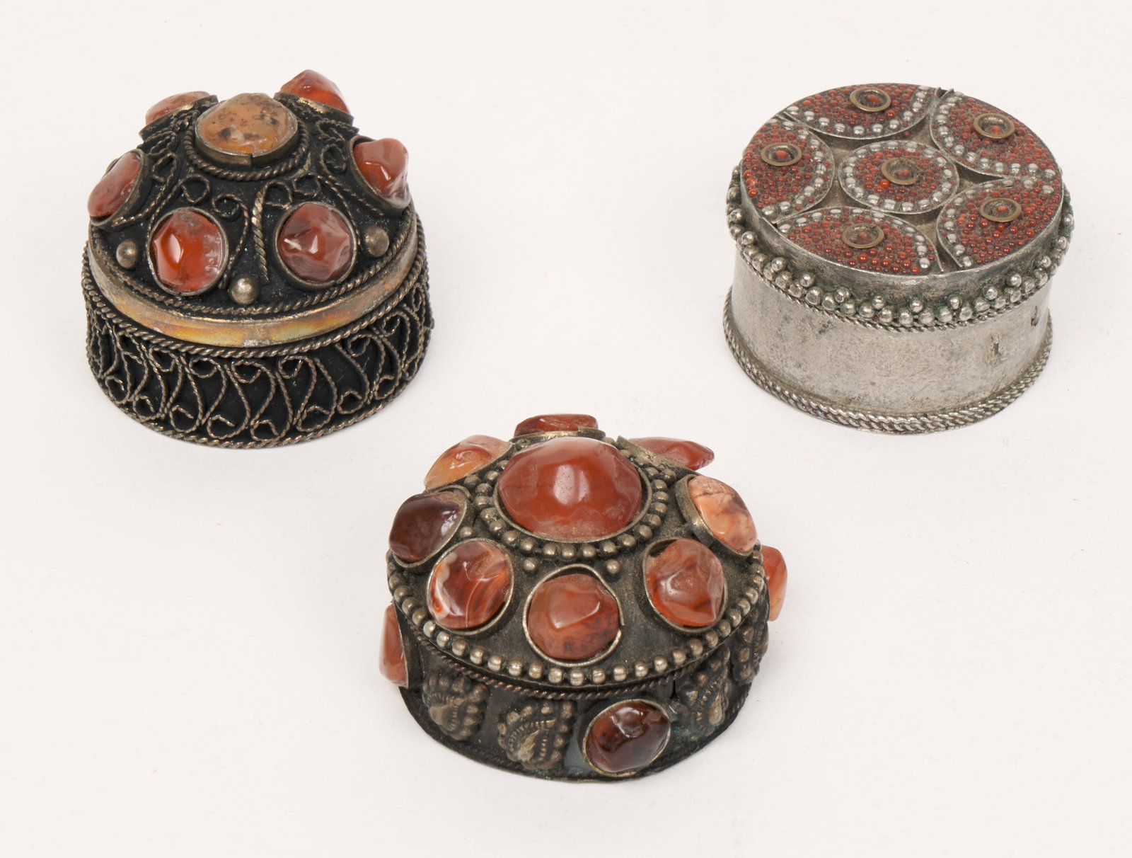 Amber and Silver Filigree Boxes (Yemen): Three silver filigree lidded boxes with stones and beads. 1 1/2 x 1 3/4" (approximate). Provenance: Estate of Professor Lorraine Hawkins (Yemen Scholar).