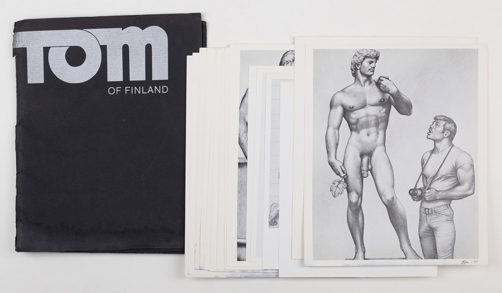 Tom of Finland Print Portfolio: Folio of 16 Tom of Finland offset prints. Letterpress folder, silver ink on black cotton paper with offset prints. 8 1/2 x 11".
