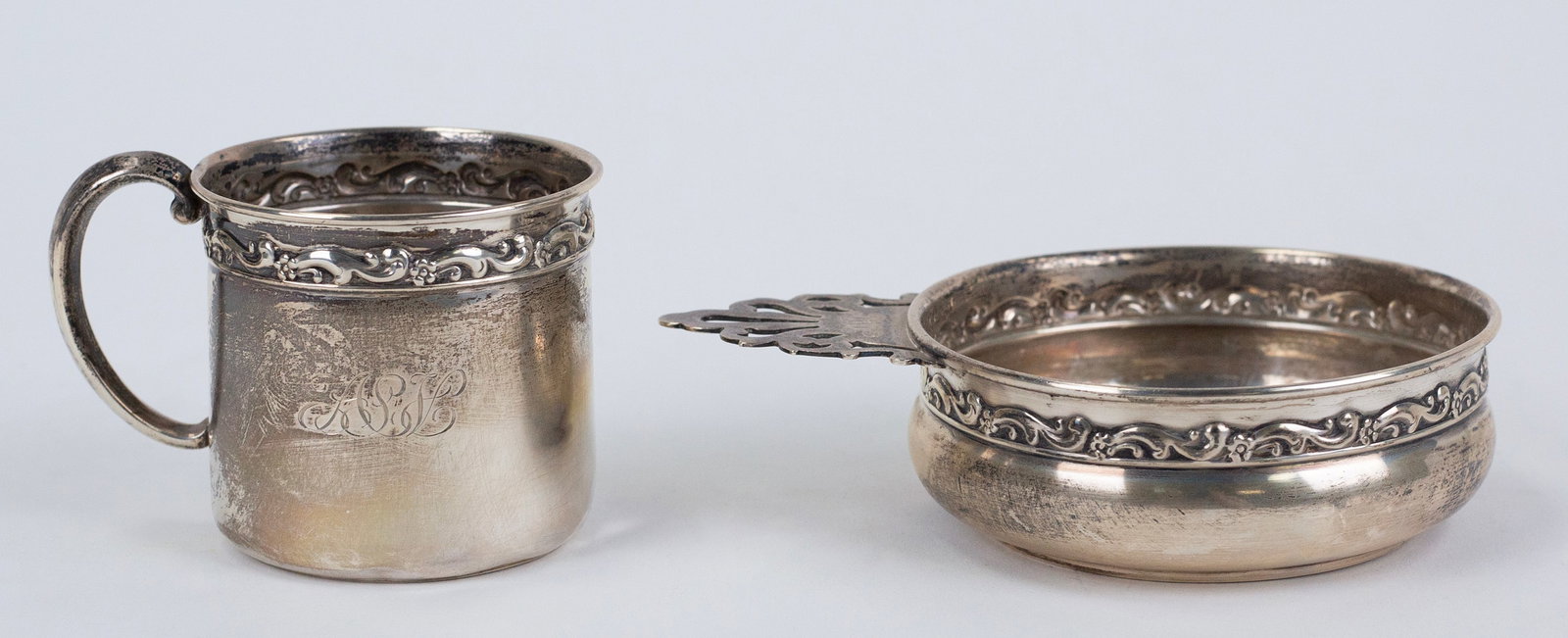 Sterling Drinking Vessels (Antique): Two pieces. One tastevin and small mug. The sterling wine taster is monogrammed on the handle, marked sterling on the bottom. 5 ½ x 4 x 2” and 2.65 ozt. One small sterling cup, monogramme