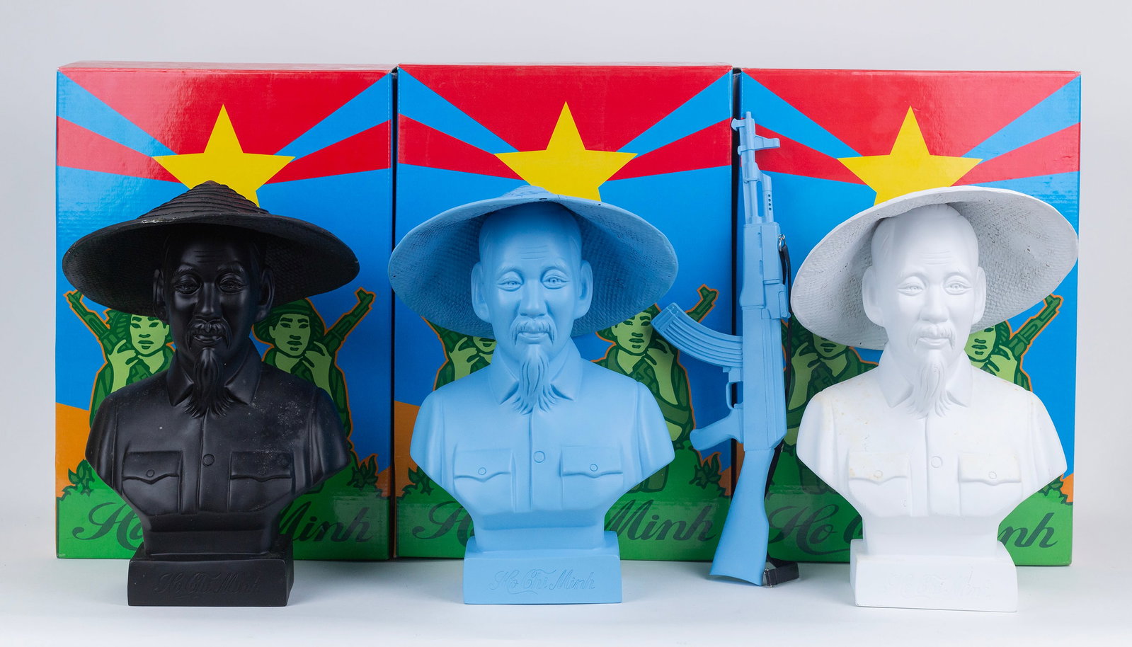 Frank Kozik (American, 1962 - 2023): Three busts. 'Ho Chi Minh (Red, White, and Black) Cast resin. 2008. One with cast resin assault rifle. Sculpture: 15 x 10 x 6". Box: 18 x 12 x 10". Provenance: Property of a Manhattan Estate.