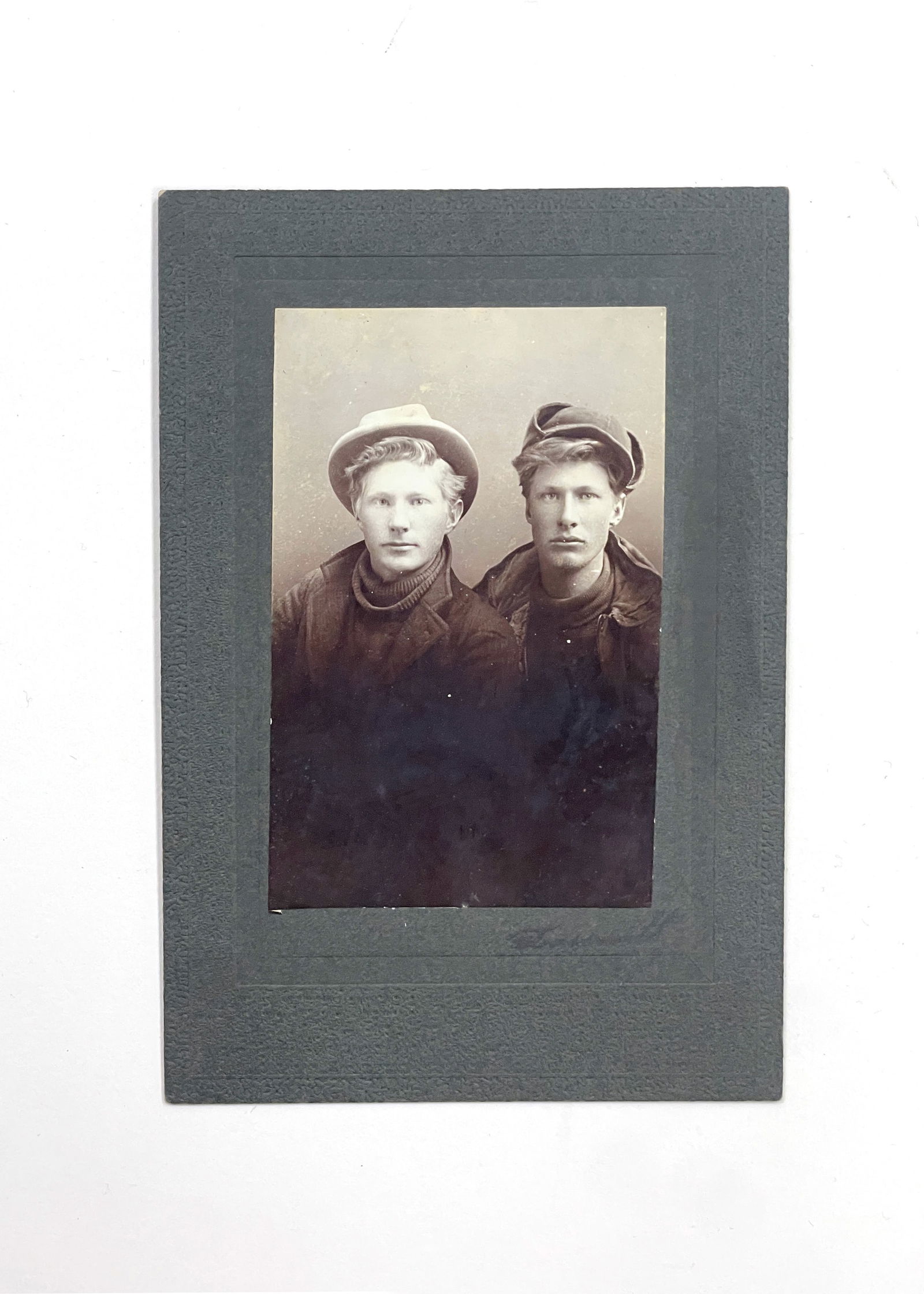 Early 20th Century Photograph: 'Portrait of Two Young Men.' Circa early 20th century. Marked with photo studio at the bottom right. Platinum print. 3 x 2"; 5 1/4 x 3 1/2".