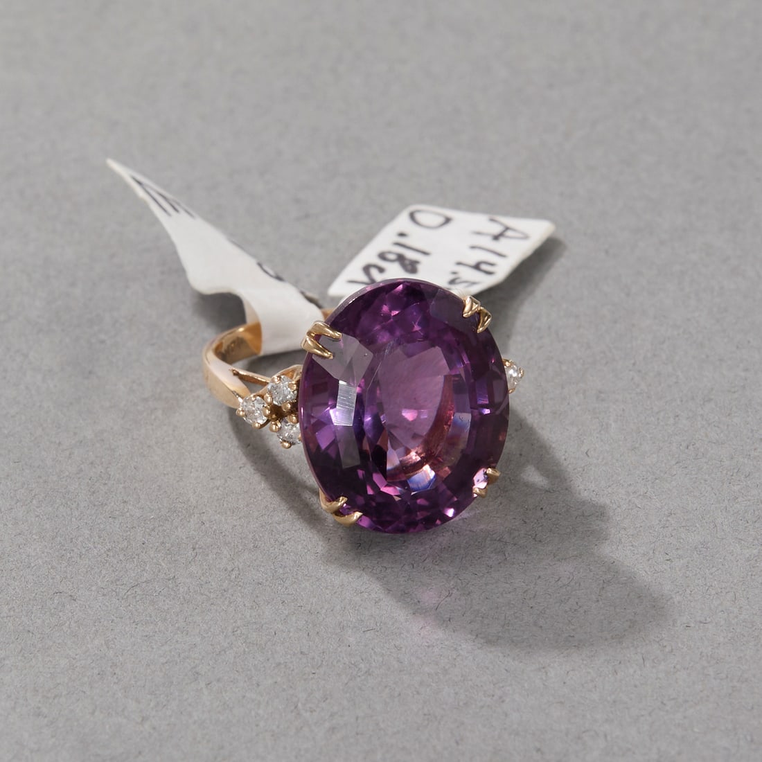 14k Yellow Gold Amethyst and Diamond Ring: Oval faceted amethyst surrounded by six (6) diamonds set in 14k yellow gold band. Marked 14k on band interior. Ring size: 6; Gross weight: 5.1 dwt. Stone size: approx. 18 x 15 x 11 mm