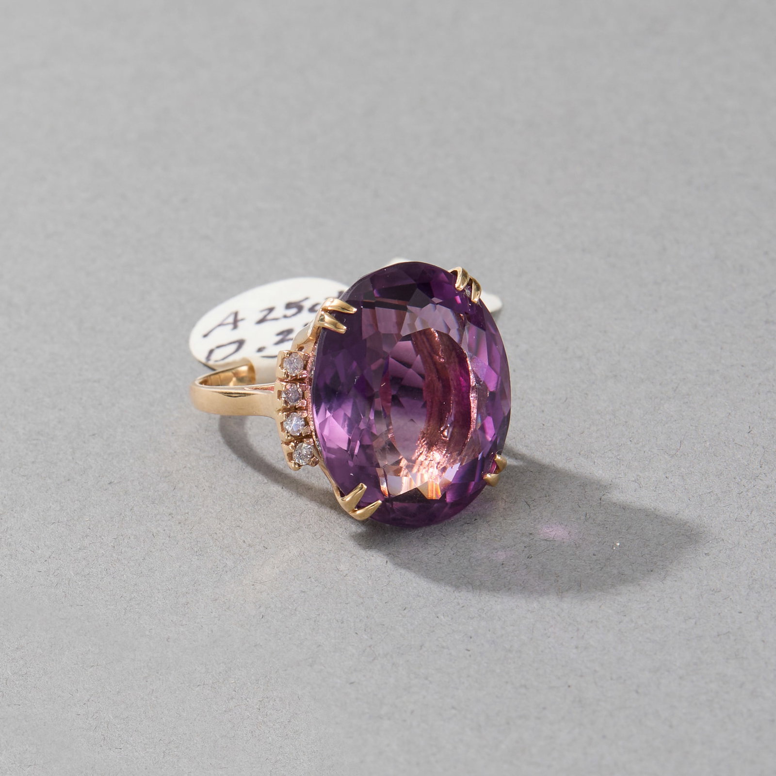 14k Yellow Gold Amethyst and Diamond Ring: Oval amethyst surrounded by eight (8) diamonds set in 14k yellow gold band. Marked 14k on band interior. Ring size: 6. Gross weight: 8 dwt. Stone size: 22.6 x 19.6 x 11.9 mm