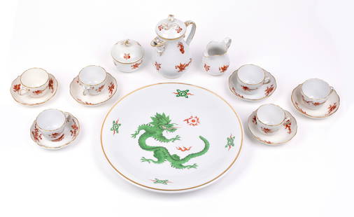 Meissen Dragon Pattern: Fifteen (15) red dragon pieces, including a teapot with creamer and sugar bowl; together with one (1) green dragon pattern platter. 12 1/4" with two ground strikes through the sword mark.