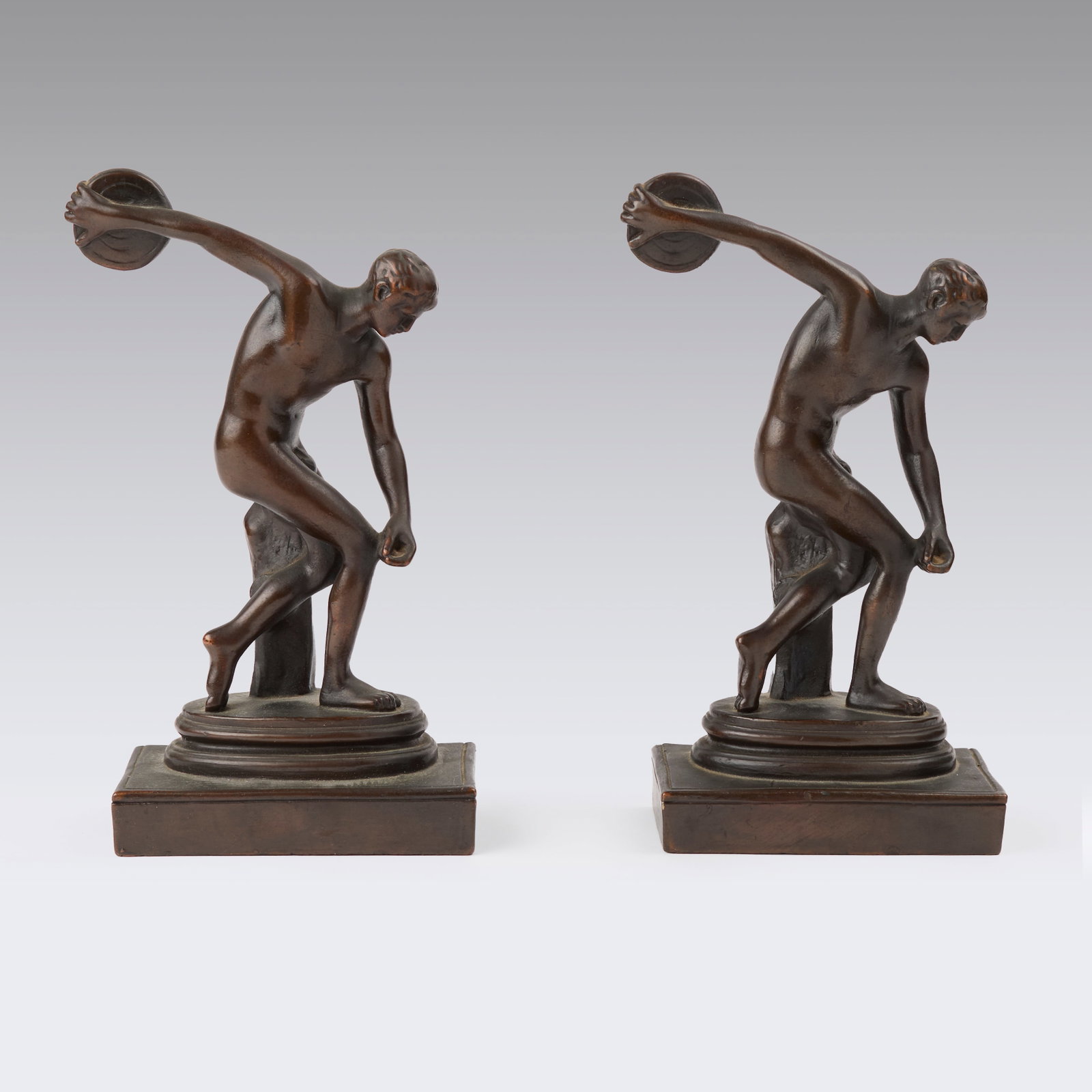 Myron, After (Greek, 480 - 440 BCE): Bookends. Marked "P.C.B. Disc Thrower." Bronze plated metal. Weight: ~ 4 lbs. Together: 5 1/2 x 4 1/2 x 8 1/4" (sight). Provenance: property of a Western Massachusetts collection. Shipping: At checkou