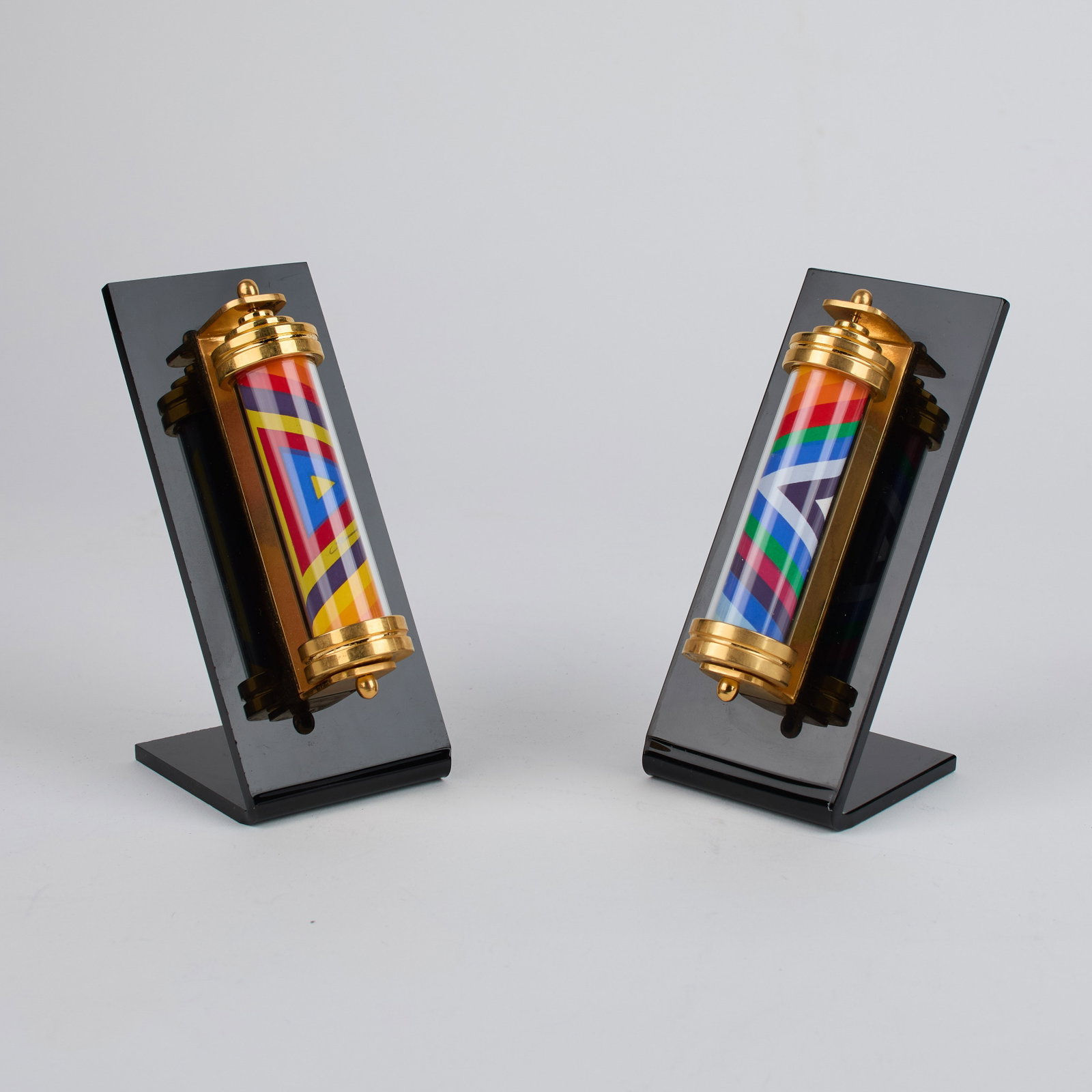 Naim Basson (Israeli, b.1935): Two (2) revolving mezuzahs mounted on black acrylic stands. Signed. Each 5 x 1". Mounted?6 x 2 1/2 x 2 1/4" (overall). Provenance: property of a Massachusetts collection. Shipping: At checkout, you ca