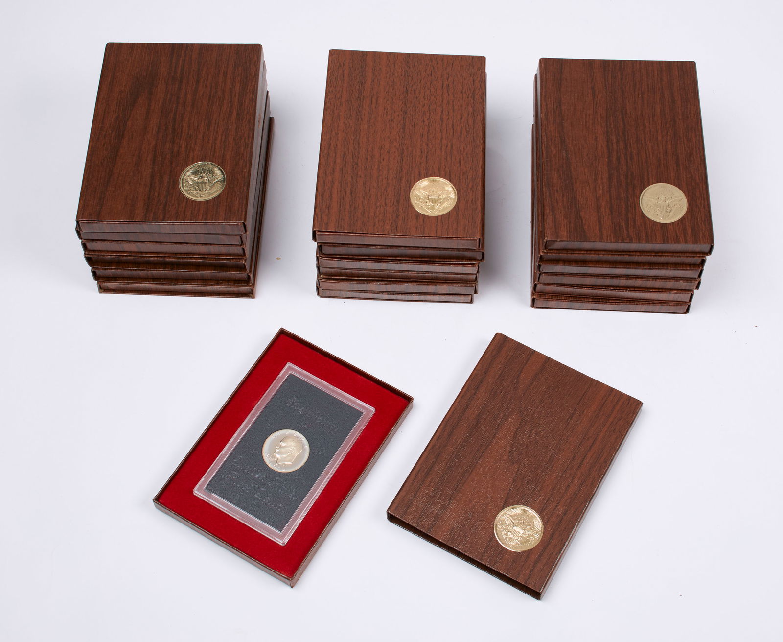 U.S. Proof Eisenhower Silver Dollars: A collection of nineteen (19) 40% silver proof Eisenhower dollars in original brown boxes. Includes fourteen (14) 1974-s dollar coins, and five (5) 1971-s dollar coins. Provenance: property of a