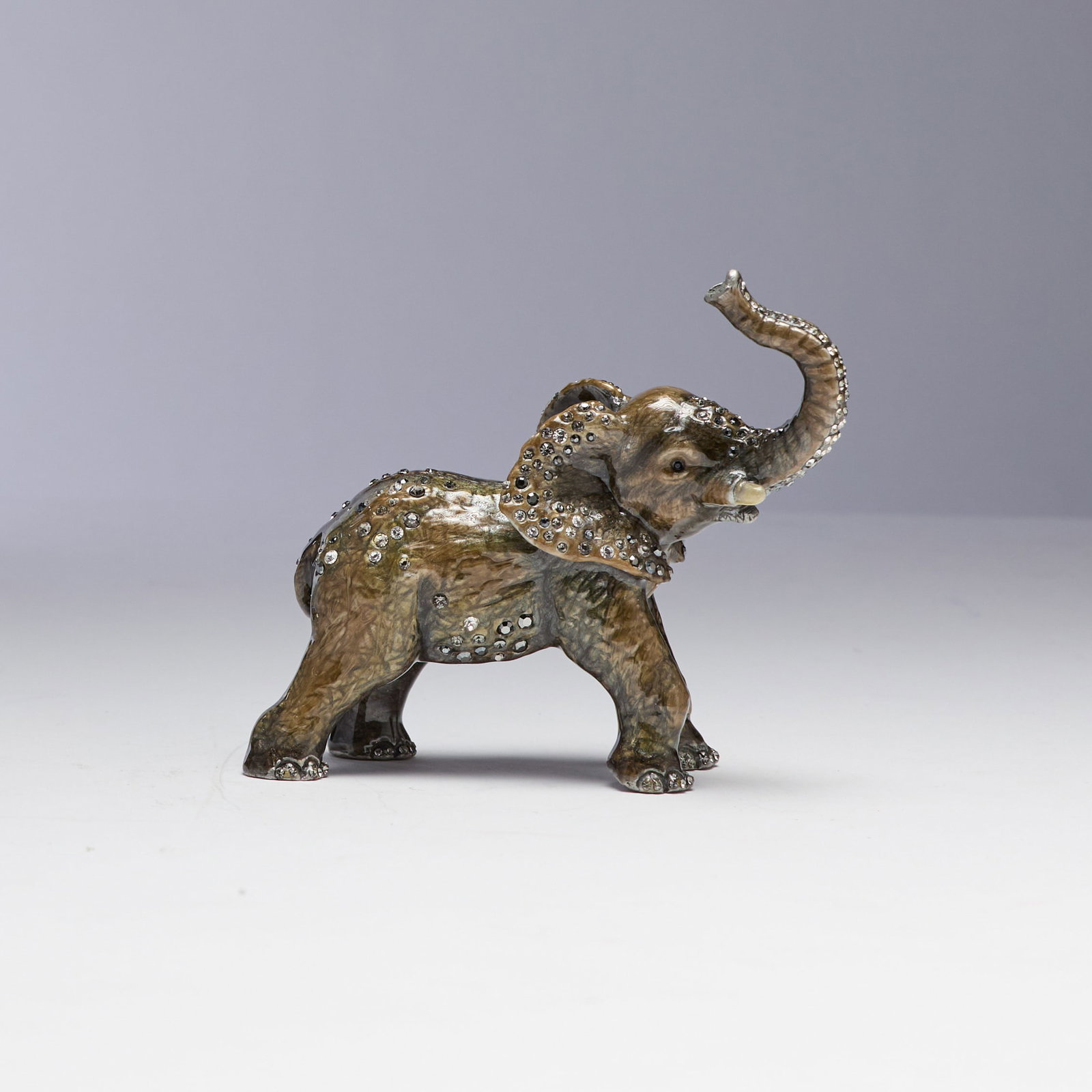 Jay Strongwater (Rhode Island): "Elmore." From the "Jungle" collection. An embellished and enameled baby elephant figurine. In original box. 3 1/2 x 4".