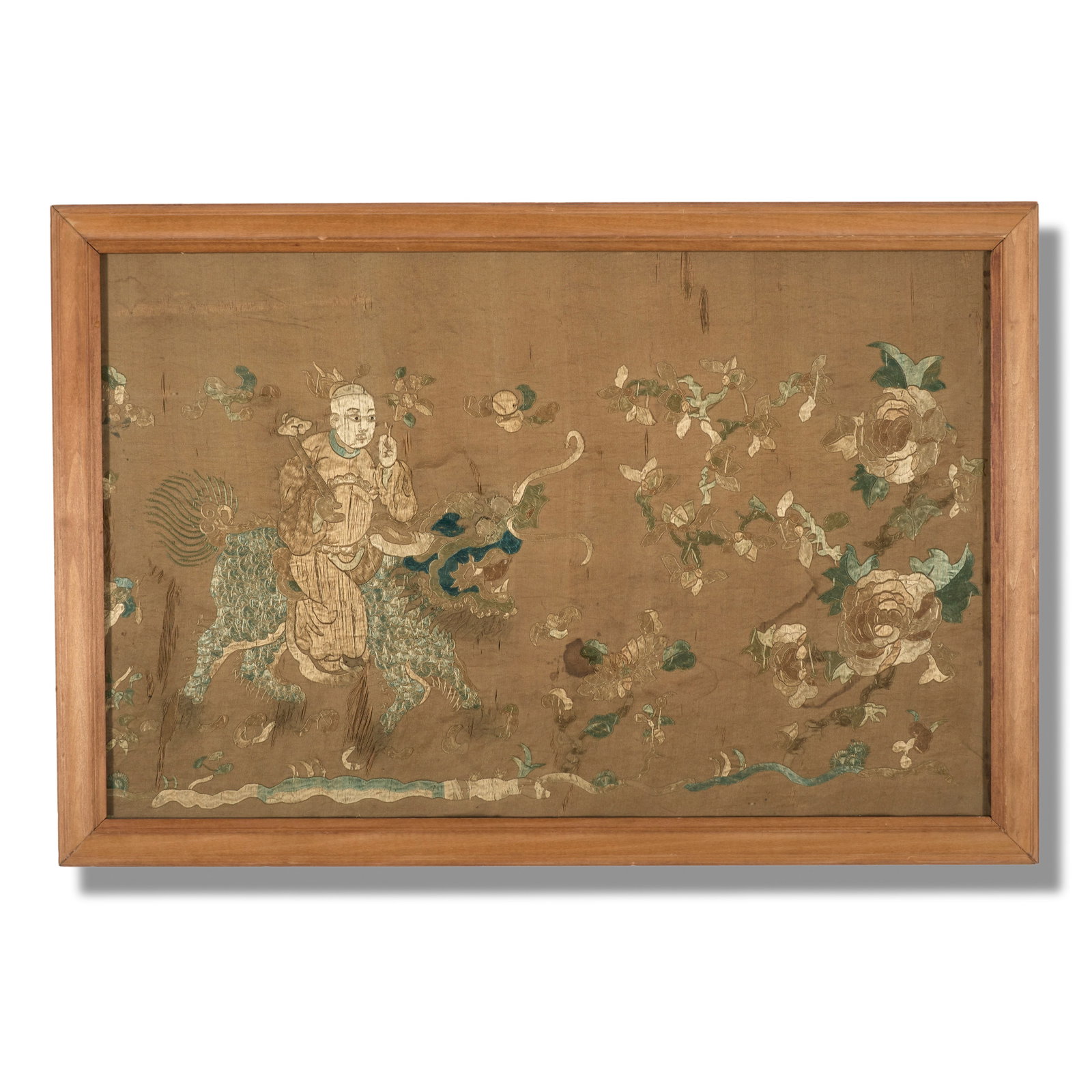 Chinese Silk Embroidery (19th Century): A Chinese silk embroidery fragment. Silk embroidery on silk cloth sheet. A depiction of a man riding a foo-dog in a floral landscape. Framed. 13 3/4 x 21 1/2"(sight); 16 1/4 x 24 1/2&