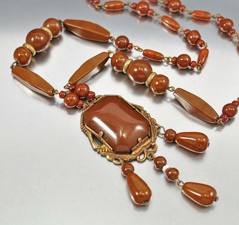 Beautiful rich chocolate brown glass beads form this st: beautiful rich chocolate brown glass beads form this stunning vintage czech art deco necklace circa 1920. the glass pendant is set in a detailed gold gilt frame with three dangling drops swaying below