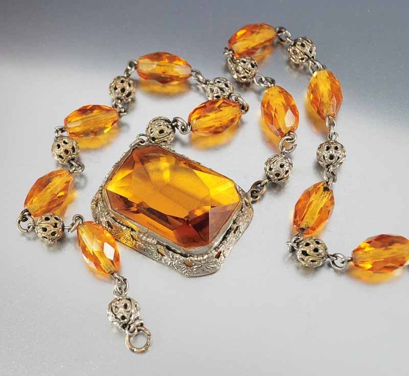 Outstanding signed Czechoslovakia vintage 1920s Art Dec: outstanding signed czechoslovakia vintage 1920s art deco necklace with a large open back amber glass pendant set high in a silver floral embossed frame. faceted czech glass beads alternate with silver