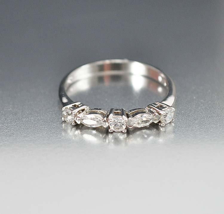 Simple and elegant Art Deco style wedding band ring wit: simple and elegant art deco style wedding band ring with a row of crystal paste cz's sparkling across the front. the half eternity band has oval and round cut prong set open back stones that dazzle wi