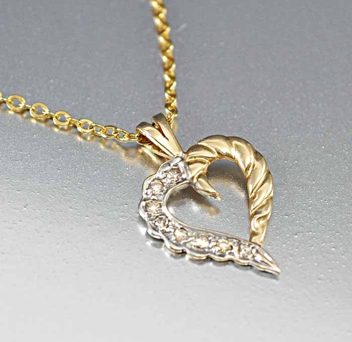 Looking for that special gift that says "I love you"? : looking for that special gift that says "i love you"? she'll swoon with this 14k yellow and white gold heart pendant with one side having 8 open back diamonds set in white gold and the other half a tw
