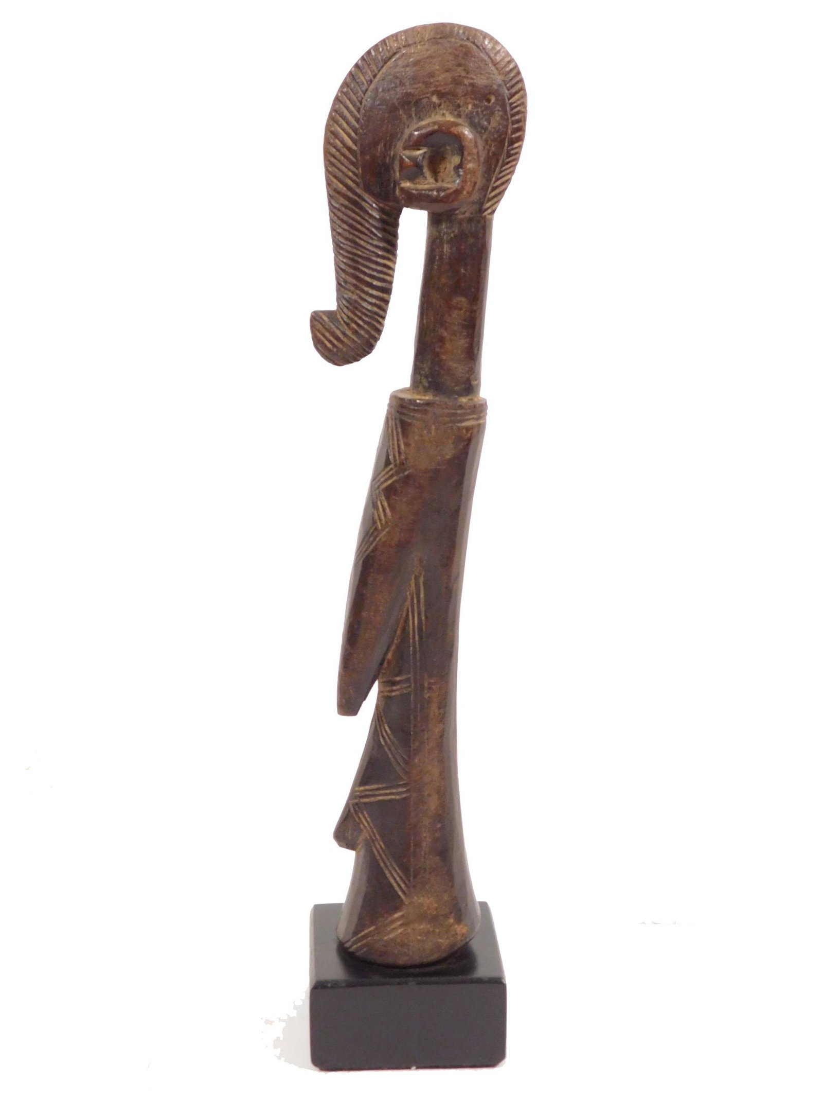 African Mossi Biga Doll, Boulsa Kingdom: Mossi People, Burkina Faso, Africa: Finely carved wooden adult female figure with a distinctive forelock coiffure extending down the front of its face. 20th Century. The figure has an elongated neck, 