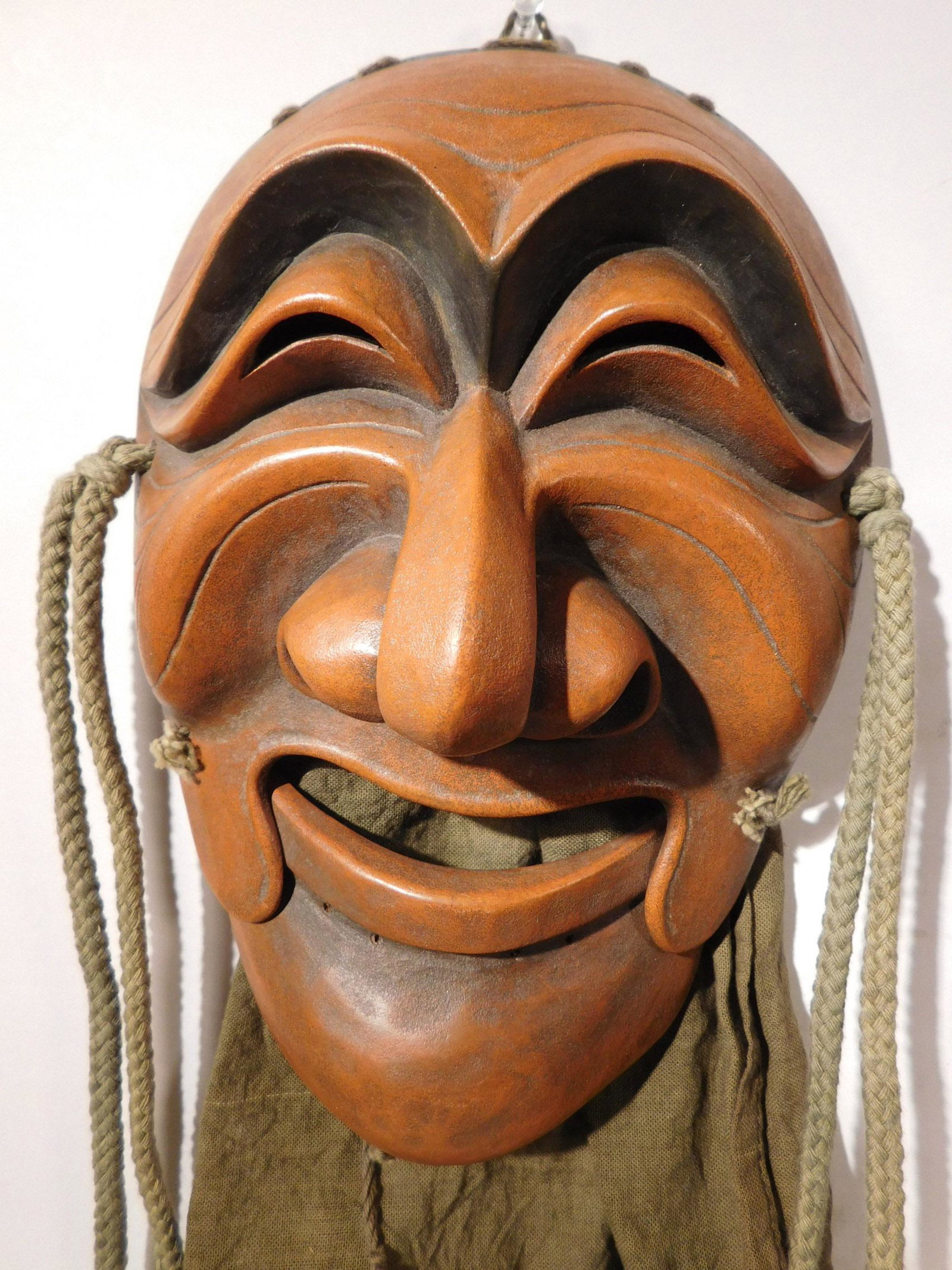 Antique Korean Hahoetal Yangban Mask: Korean Hahoetal Mask with Articulated Jaw and Fabric Hood, depicting Yangban (the aristocrat), 18th Century (dated circa 1766 by near infrared spectroscopy). This exquisitely carved Korean alder mask 