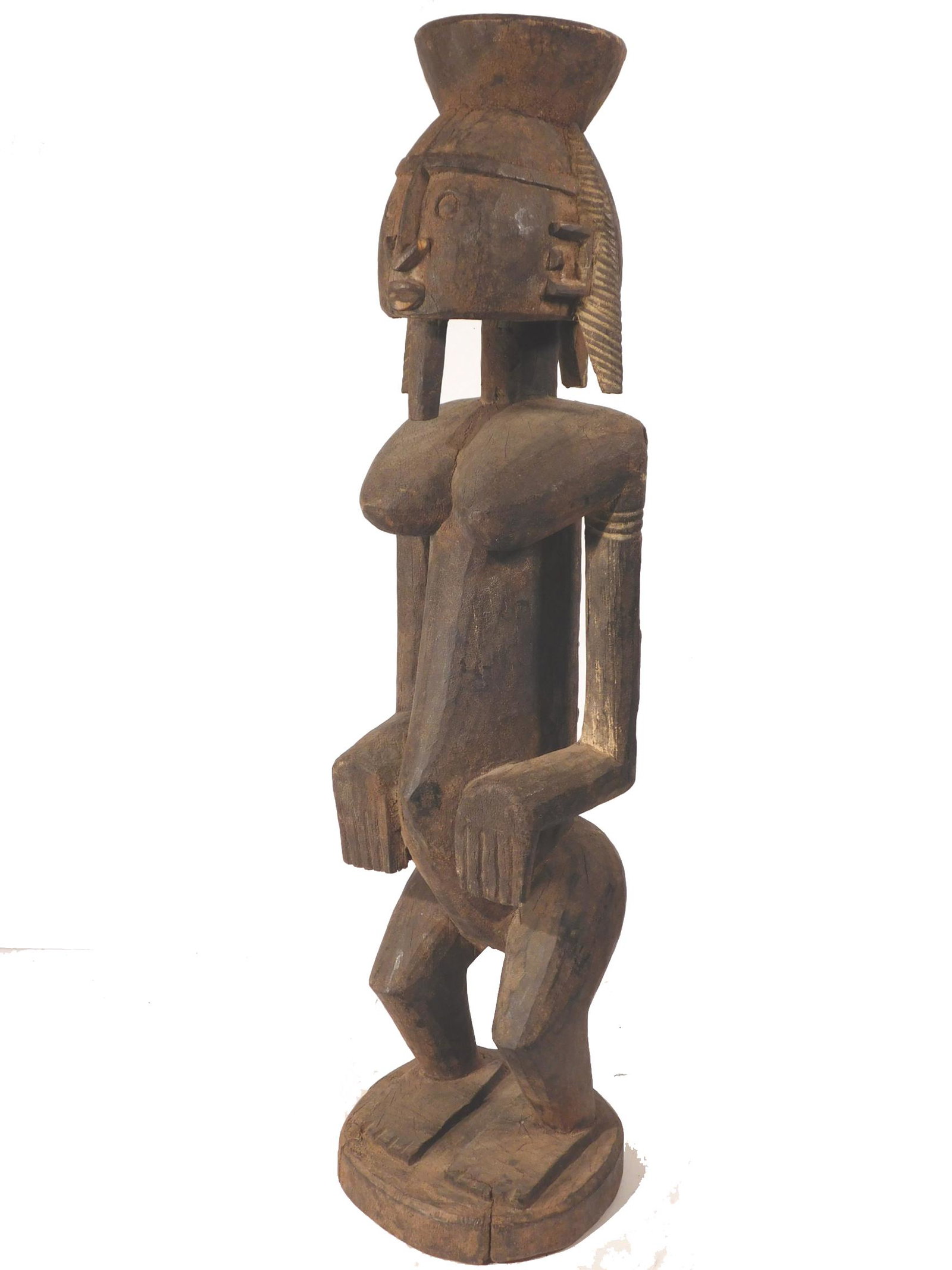 African Dogon Maternal African Sculpture: This impressively scaled (29" High) depiction of a vessel-bearing woman shows a traditional hair style and also a beard. On her back is a female child. Its estimated age is late 19th century (Circa 18