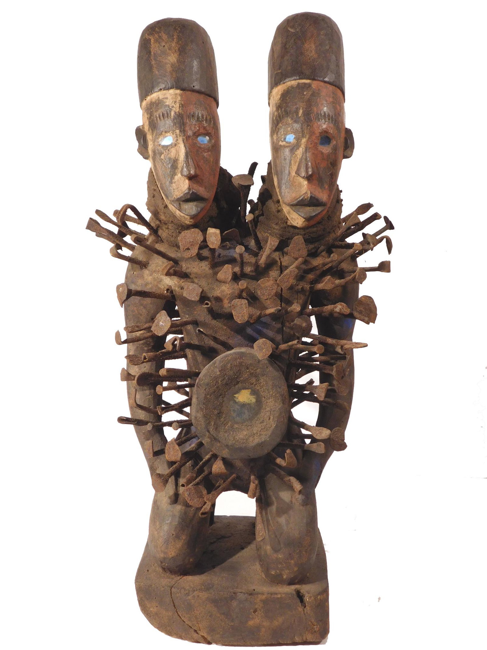African Two-Headed Bakongo Nikisi Sculpture: Two-Headed Nkisi Figure, from the Bacongo people, Democratic Republic of Congo, late 19th Century, circa 1884. Made of wood, pigments, fabric, glass nails and natural elements. A nkisi (plural: minkis