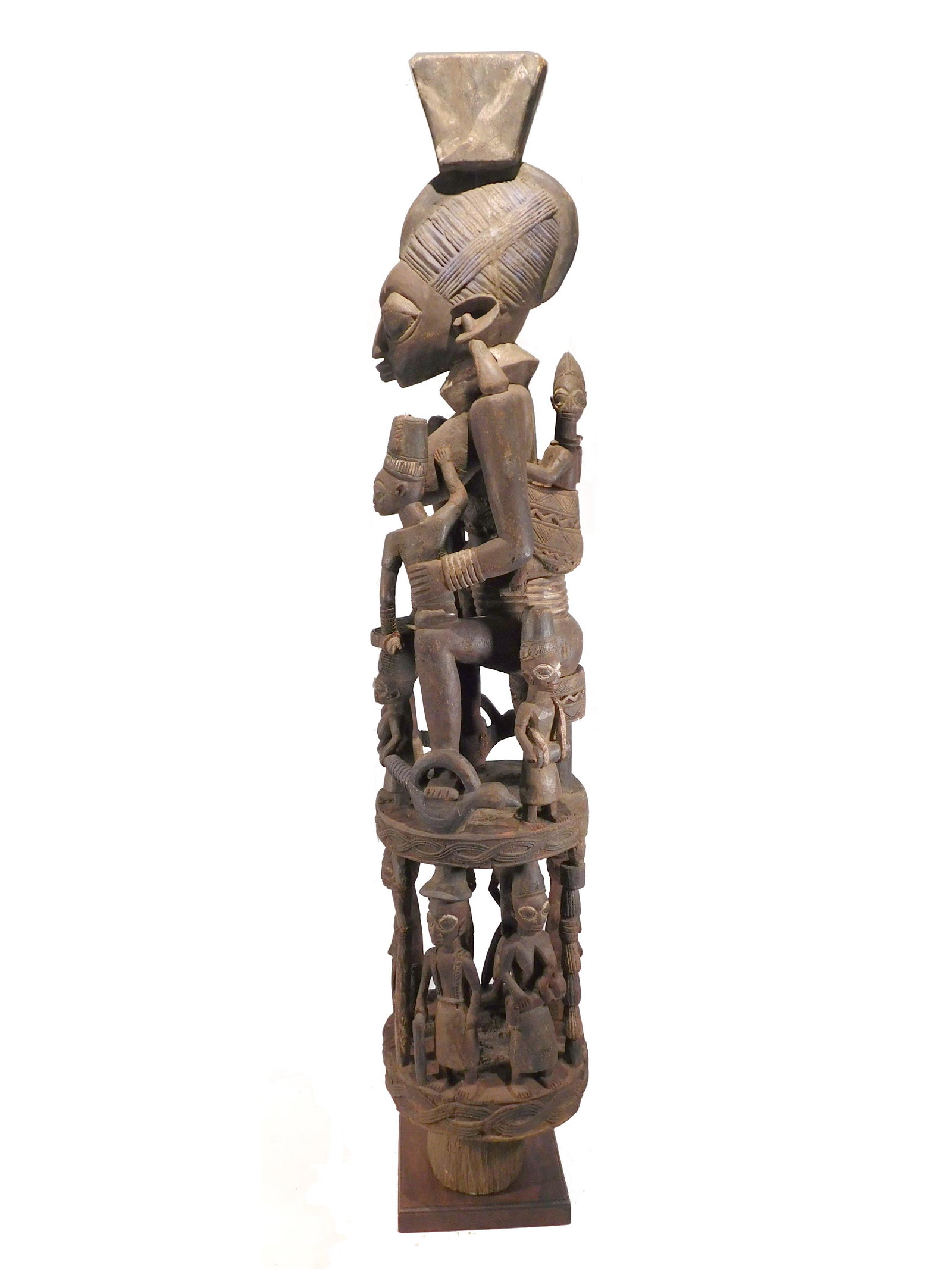 House Post with Queen, Yoruba People, Nigeria: Yoruba People, Nigeria: House post, carved wood enhanced with pigments, Early 20th century. The post is designed to stand at an entryway, and shows the status of the occupants within. The main figure 
