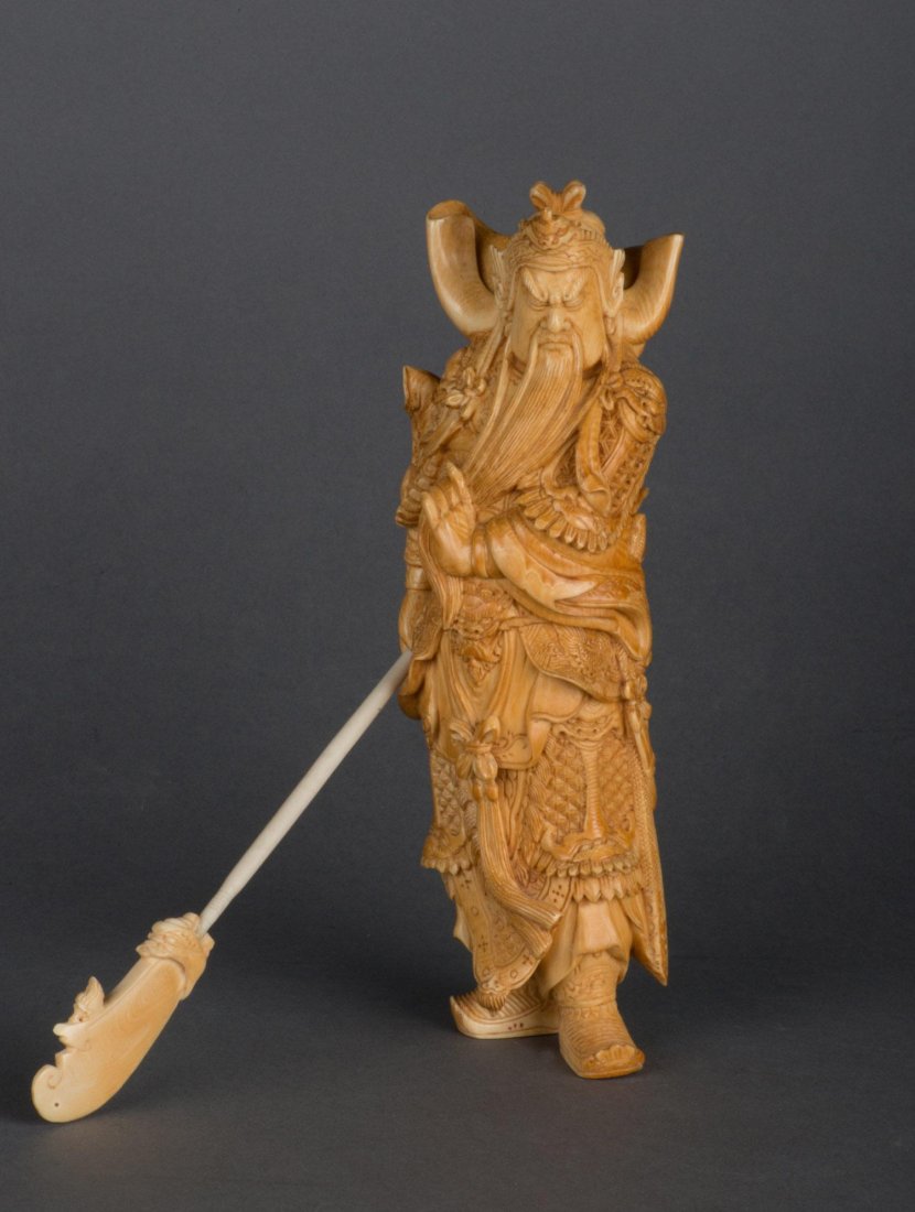 A VERY FINE IVORY CARVING OF GUAN YU WITH STAFF, QING D: A VERY FINE IVORY CARVING OF GUAN YU WITH STAFF QING DYNASTY, 18TH CENTURY a beautifully carved yellow ivory statue with striking armor and facial features, supported by a downturned staff with an ivo