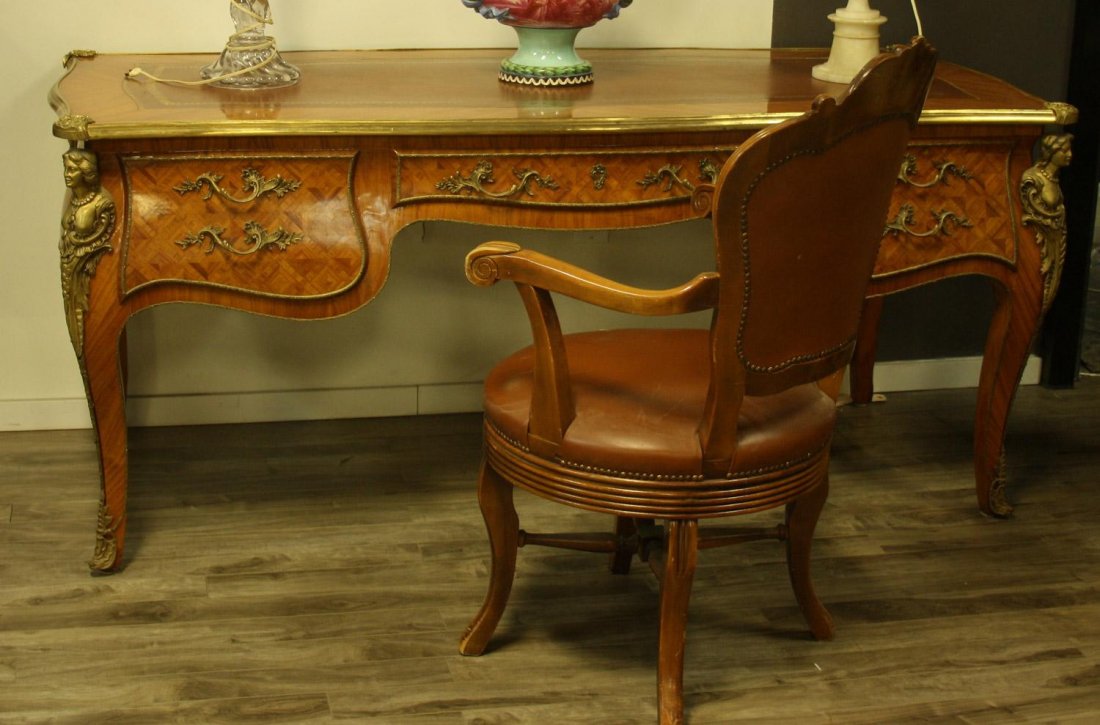 Leather topped satinwood desk with marquetry and ormolu: Leather topped satinwood desk with marquetry and ormolu style brass mounts. Comes with brown leather swivel chair.Estimate $2,000/2,500