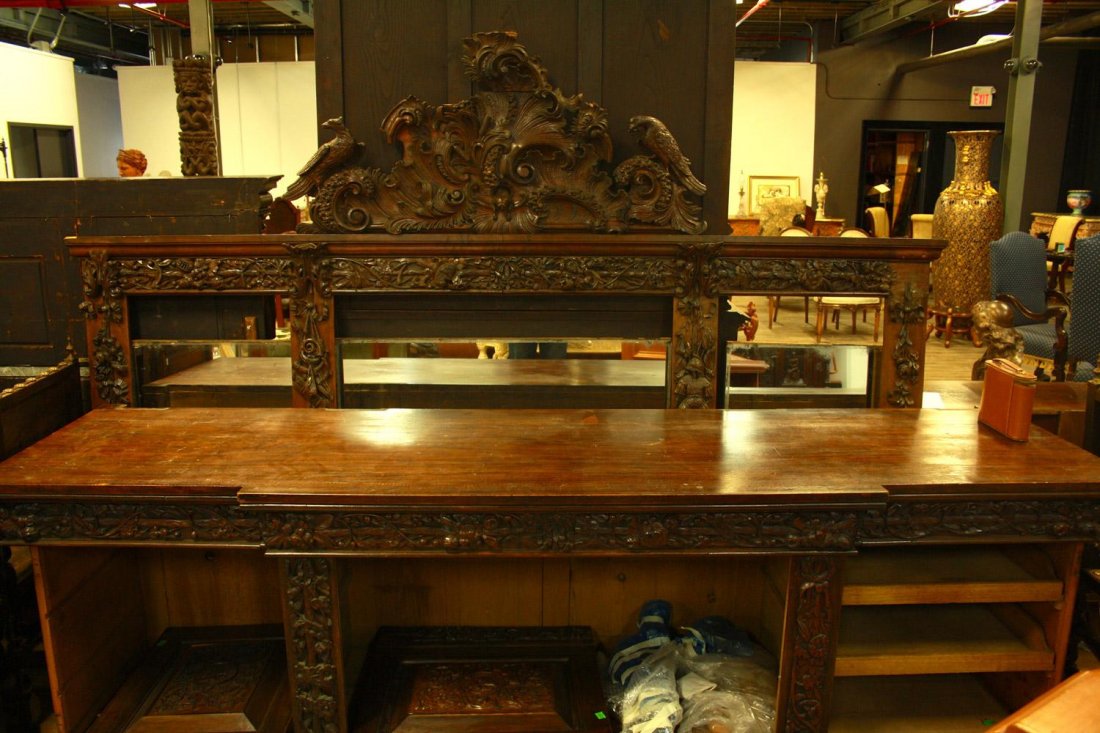 A RENAISSANCE REVIVAL BREAKFRONT SIDEBOARD,: A RENAISSANCE REVIVAL BREAKFRONT SIDEBOARD A rare 19th century Renaissance revival carved oakwood breakfront sideboard, the cornice carrying ornately-carved pierced coquillage flanking an exuberantly 