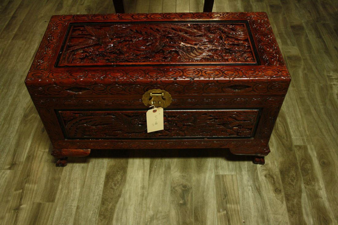 A RED LACQUERED WOODEN TRUNK WITH A GLASS COVER, POST-R: A RED LACQUERED WOODEN TRUNK WITH A GLASS COVERPOST-REPUBLICAN PERIODThe body rising from four claw-carved feet and culminating in a flat lid with brass clamps covered by a glass screen, the exterior