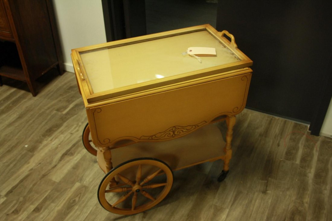 A WALNUT TEA TROLLEY WITH CARRIAGE-STYLE WHEELS: A WALNUT TEA TROLLEY WITH CARRIAGE-STYLE WHEELSEstimate $60/80