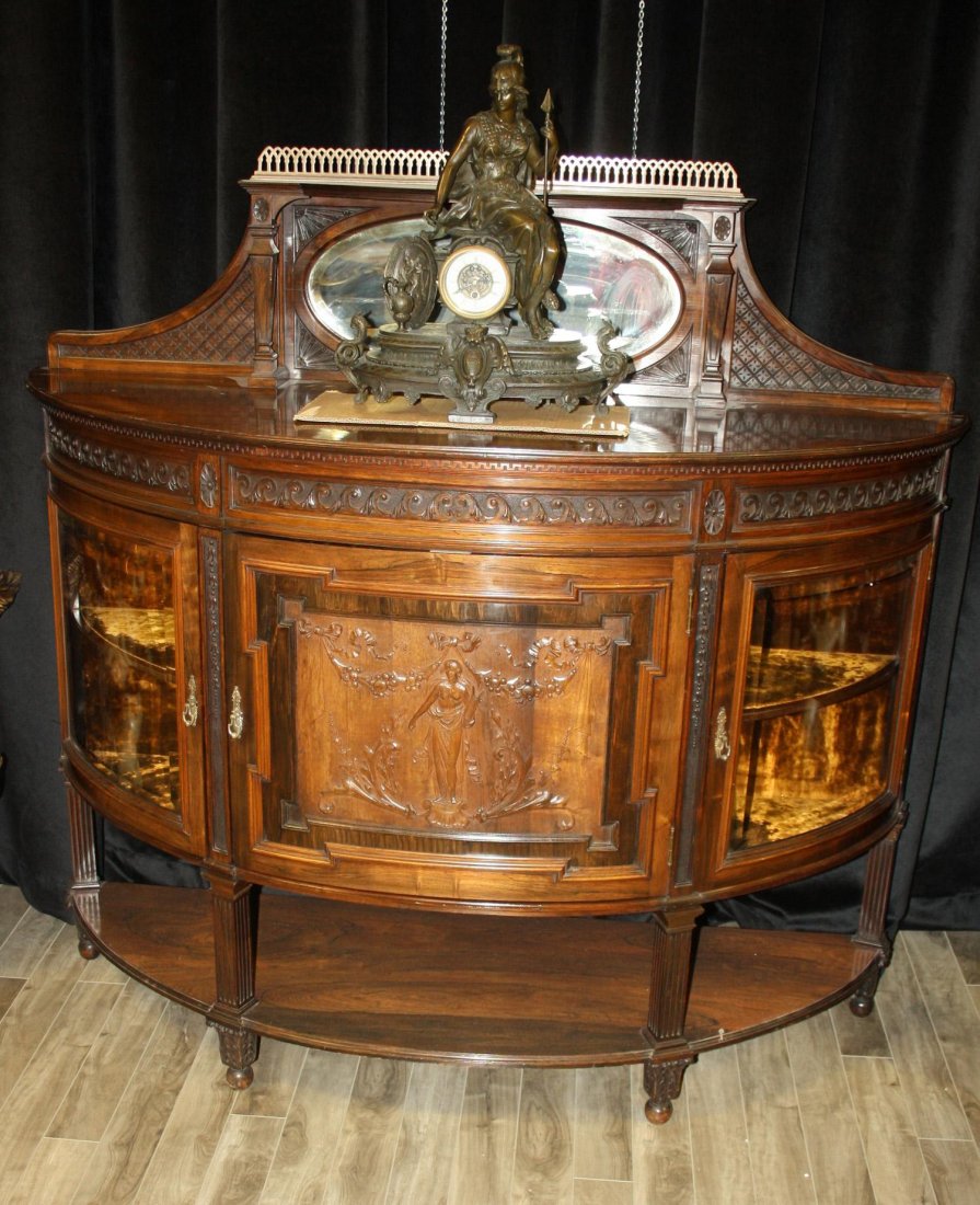 A rosewood “D” shaped buffet with mirrored : A rosewood “D” shaped buffet with mirrored back gallery. A solid, hand carved, rosewood “D” shaped buffet with mirrored back gallery. Two side doors with glass panels. Centre d