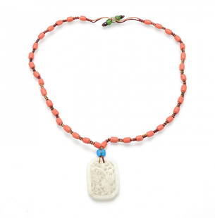 A FINELY-INCISED WHITE JADE CARVING WITH A RED CORAL: A FINELY-INCISED WHITE JADE CARVING WITH A RED CORAL NECKLACEQING DYNASTY (1644-1912)清 和闐白玉鏤空雕鳳尾鳥項鏈a reticula