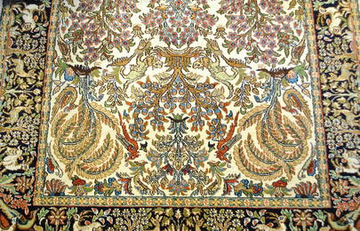 A KASHMIRI SILK ON COTTON RUG WITH ANIMAL MOTIFS