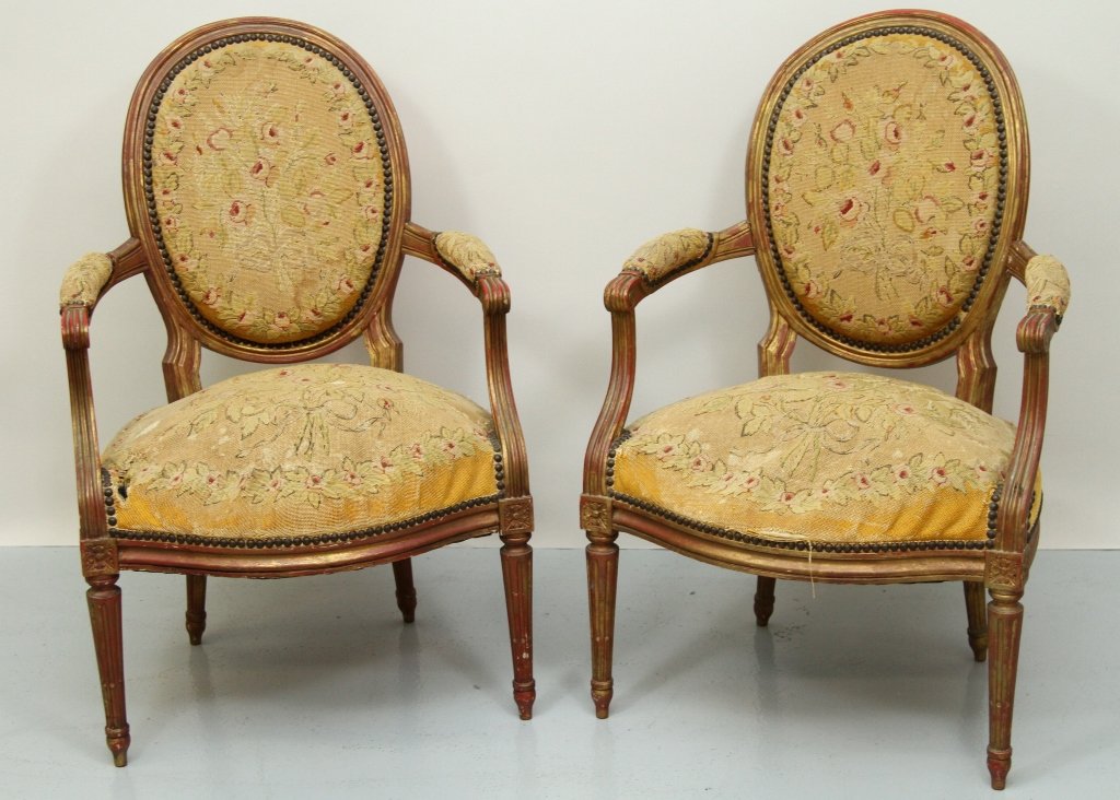 ANT. FRENCH PR OF OVAL BACK NEEDLEPOINT ARM CHAIRS: Pair of French gilt wood fauteuil with needlepoint upholstery. 35.25"H X 22.75"W X 18.5"D Seats and fabric need to be repaired