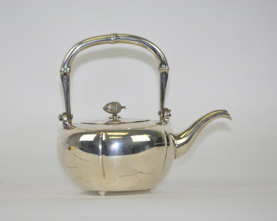 Japanese pure silver kettle / wine pot signed Ikoma: This elegant kettle has a long slender sprout and stands on three round feet.The handle is shaped like bamboo and the knob a pinecone. 7.25" (18.4cm) on the widest part. 6.25"(15.5) Weigh13.2oz(375g).