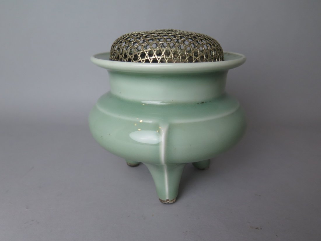 Chinese Celadon-Glazed Porcelain Tripod Censer: Chinese Celadon-Glazed porcelain tripod censer with silver cover. Qing Dynasty. D:12 cm, H:11 cm.