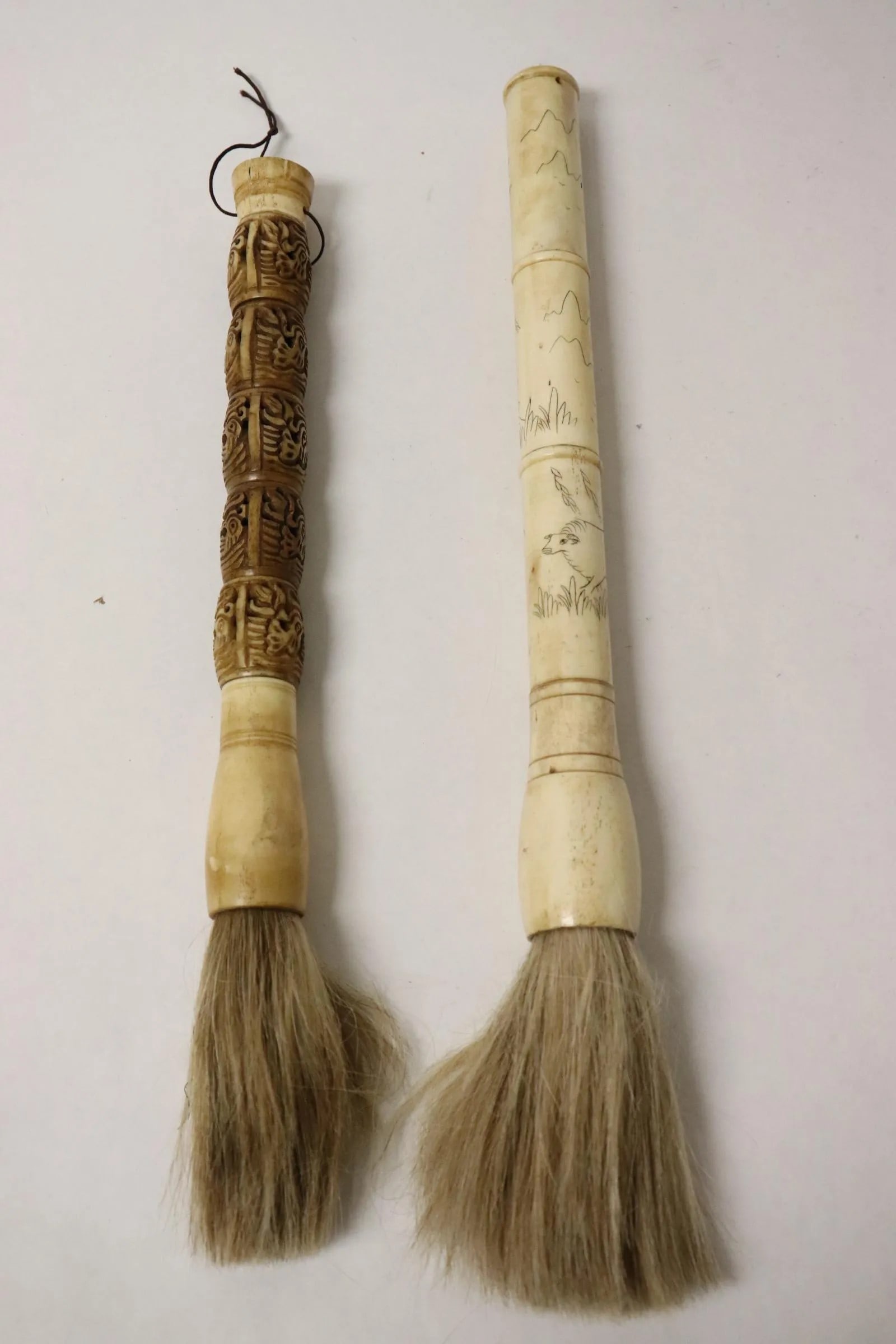 2 large painting brushes with carved bone stems: 2 large painting brushes with carved bone stems, 13.5"L, 15.6"L