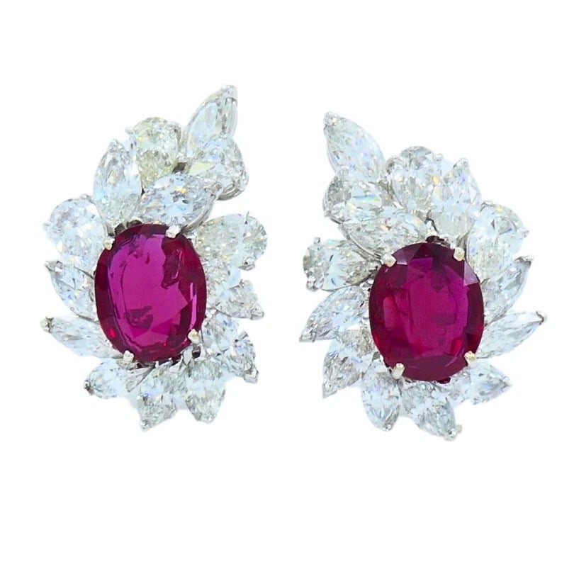 RUBY AND DIAMOND FLORAL CLUSTER CLIP EARRINGS (20TH CENTURY): RUBY AND DIAMOND FLORAL CLUSTER CLIP EARRINGS (20TH CENTURY) Provenance and Authenticity: These elegant clip earrings feature a pair of richly colored oval ruby center stones surrounded by an intricat
