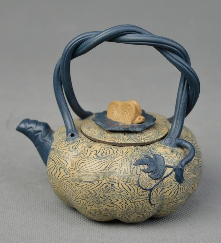 A Twistable Tire Pumpkin Shaped Yixing Teapot, signed (1 of 5)