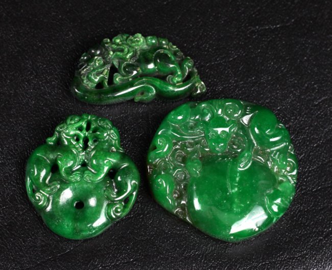 # Chinese Jade Plaques: Includes one with monkey and peach, one with chilong and foo dog, and other with two dragons atop disc. Largest 2" H.