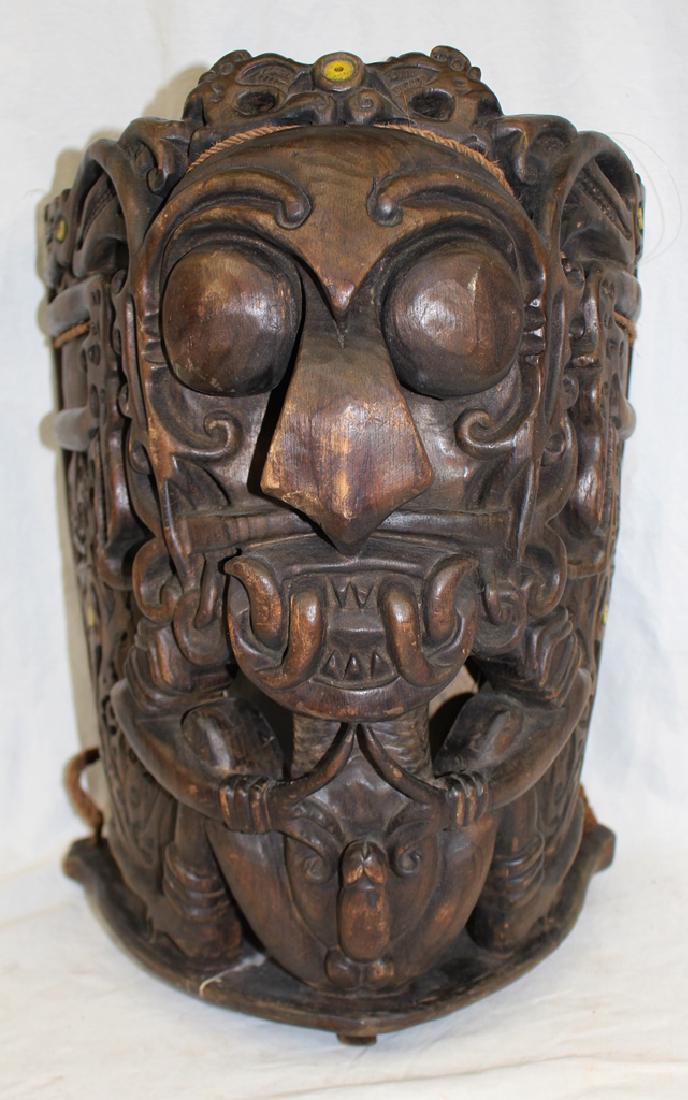 Southeast Asia Carved Wood Baby Carrier for Male Babies: Heavily carved wooden baby carrier that measures 18" tall, 12" wide and 10" deep. Very detailed carving with large male organs on front indicating this would have been carved for male babies. Mid 20th