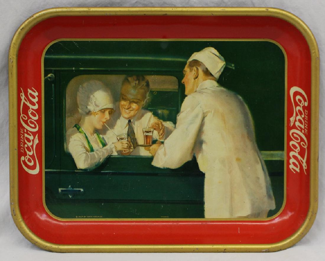 1927 Coca Cola Car Hop Serving Tray: Surface is slightly dull with a few random marks and scratches. General overall medium to mild border and rim wear.Condition (Very Good). Size 13 - 1/4" x 10 - 1/2". Small dent at middle top that coul
