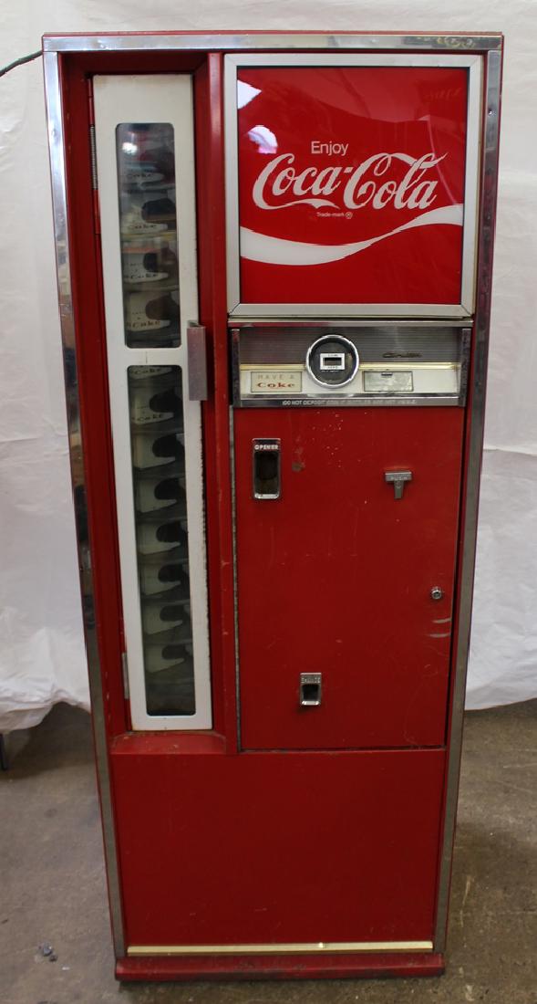 Cavelier 5¢ Coca Cola Bottle Machine: Cavelier 5¢ Coca Cola Bottle Machine in what seems to be good working condition. Holds 8 ounce bottles of Coke. When plugged in the compressor turns on and cools down the unit. 5¢ coin mechanism als