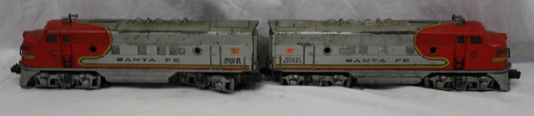 LIONEL O GAUGE #2333-20 SANTA FE F-3 DIESEL ENGINES: Well loved and well played with original Lionel Sante Fe engine and dummy car. Part of an estate, untested by us so sold as is. Suggested bid $100