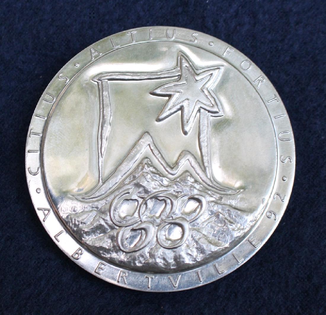 1992 Winter Olympics Albertville Participation Medal: An Albertville 1992 Winter Olympic Games participation medal, designed by Renee Mayot, chrome plated steel, the obverse with stylised flame emblem of the Albertville Games, Olympic Rings and legend, t