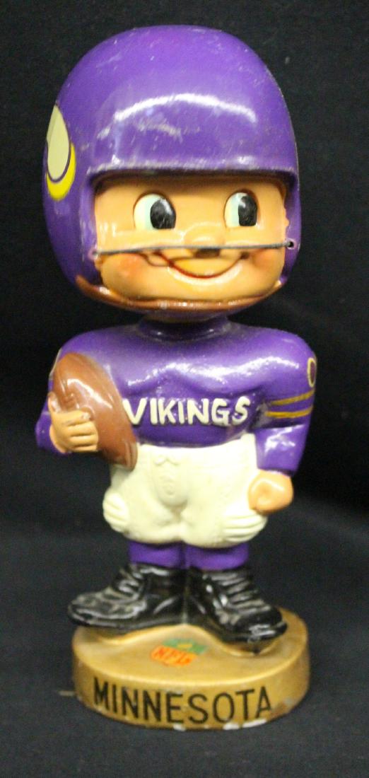 Minnesota Viking Toes Up Gold Base Bobbing Head Doll: Minnesota Viking Toes Up Gold Base Bobbing Head Doll. Ball held vertically. A couple of cracks at the base of the helmet. The worst is a 1" crack on the back. All are repairable. Suggested bid $75