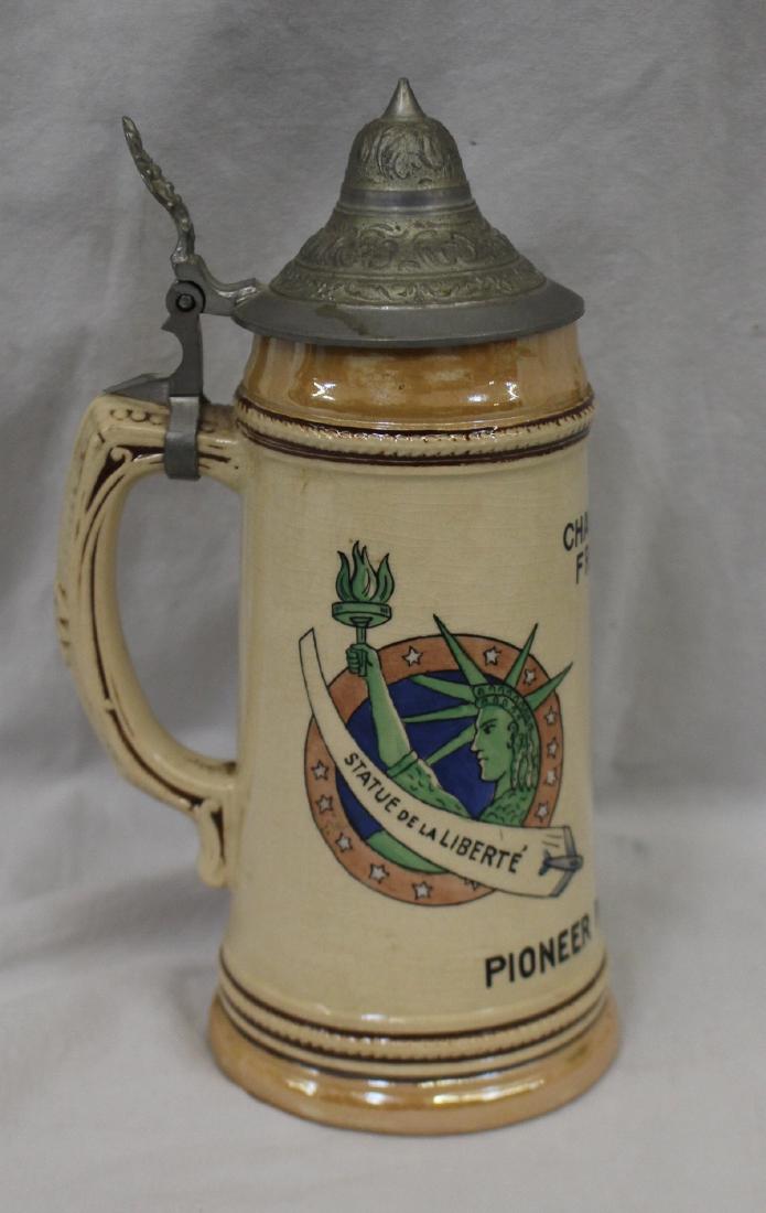 Pioneer Rocker Mess Beer Stein Chaumon France: Pioneer Rocker Mess Beer Stein Chaumon France. 9" tall stein that features the Statue of Liberty on one side and WWII era U.S. aircraft on the other. Made in Germany. Suggested bid $75