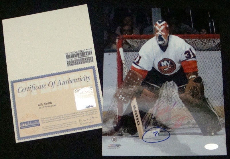 Billy Smith Autographed 8x10 Photo, Steiner: Billy Smith Autographed 8x10 Full Color Photo; great action photo of the Islanders goalie; signed in blue sharpie marker with '31' inscription; comes with a COA from Steiner.