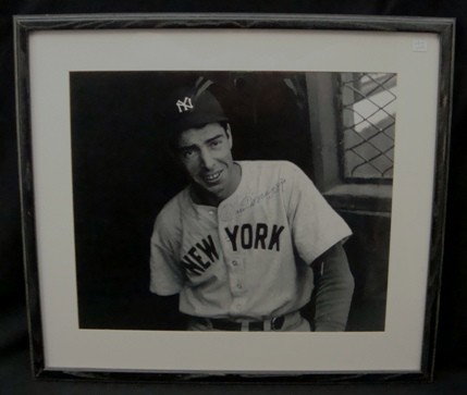 Joe DiMaggio Autographed B&W Photo, JSA LOA: Joe DiMaggio Autographed Black and White Photograph, framed and matted; shows DiMaggio in NY Yankees uniform in the dugout; measures approx 15-1/2" x 19" H; signed in blue fiber-tip marker across the 